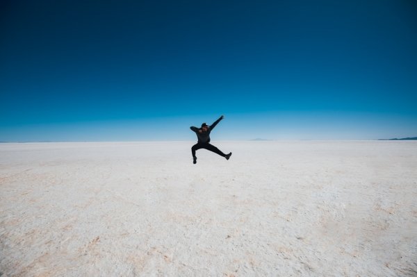 man jumping on desert