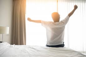 Man wake up and stretching in morning with sunlight | Premium Photo